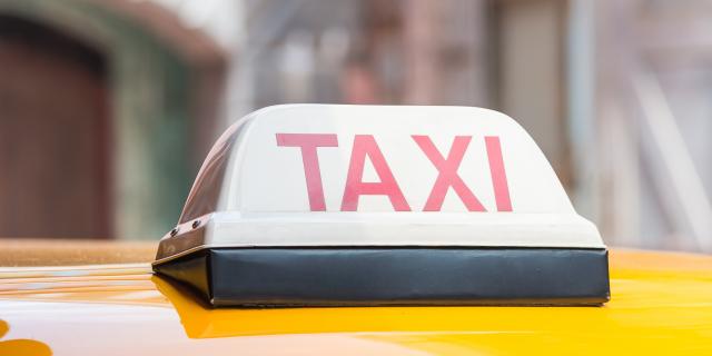 Taxi sign on roof top car